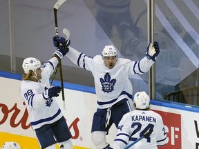 Toronto Maple Leafs forward Auston Matthews celebrates with forward William Nylander and forward Kasperi Kapanen after scoring the game winning goal against the Columbus Blue Jackets  during overtime of game four of the Eastern Conference qualifications at Scotiabank Arena.