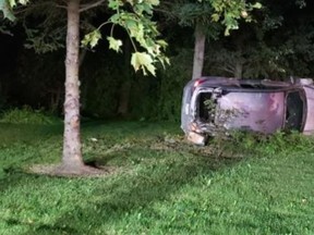 A car rests on its side after leaving the roadway north of Bolton on Aug. 15, 2020. A 39-year-old Brampton man was charged with impaired driving.