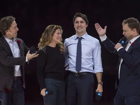 Co-founders Craig (left) and Marc Kielburger (right) introduce Prime Minister Justin Trudeau and his wife Sophie Gregoire-Trudeau as they appear at the WE Day celebrations in Ottawa on Nov. 10, 2015.