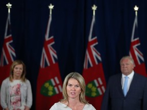 Ontario Associate Minister of Children and Women's Issues Jill Dunlop makes an announcement as Premier Doug Ford and Minister of Health Christine Elliott look on at the legislature in Toronto on Thursday, June 25, 2020.