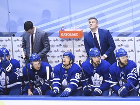 Maple Leafs head coach Sheldon Keefe (back right) looks at the scoreboard in the final seconds of of Game 1 against the Columbus Blue Jackets on Sunday. If it makes Keefe feel better, Pat Burns and Pat Quinn both lost their first playoff games behind the Maple Leafs bench.