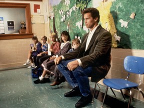 Arnold Schwarzenegger, right, in the movie "Kindergarten Cop."