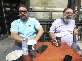 The Kit Kat restaurant on King St. W. has officially closed after 31 years of operation. Owners John Carbone (L) and his brother Al Carbone (R) sit outside the Italian restaurant on Friday, Aug. 28, 2020.