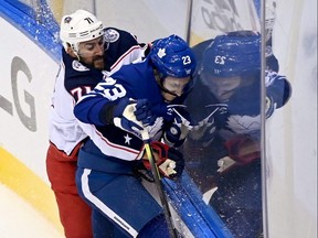 Columbus Blue Jackets left winger Nick Foligno checks Toronto Maple Leafs defenceman Travis Dermottduring Game 1 of their Stanley Cup series on Sunday. THE CANADIAN PRESS