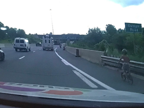 An image released by the Burlington detachment of the Ontario Provincial Police of a child riding his bicycle along Hwy. 403 in Hamilton on Monday, Aug. 17, 2020.