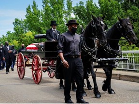 The late U.S. Congressman John Lewis, a pioneer of the civil rights movement and long-time member of the U.S. House of Representatives who died July 17, is carried via horse-drawn carriage across the Edmund Pettus Bridge in Selma, Alabama, U.S. July 26, 2020.