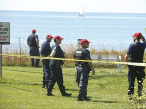 Durham Regional Police officers search at the bottom of Frisco Rd. in Pickering Friday August 7, 2020, the day after the body of an infant boy  washed up on the shoreline.