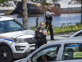 RCMP officers maintain a roadblock as they search for a suspect after a Bridgewater Police Service officer was stabbed as he responded to a domestic violence complaint at The Bridgewater Hotel in Bridgewater, N.S. on Tuesday, July 21, 2020.