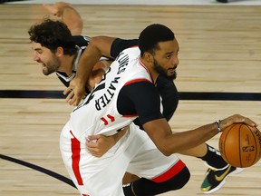 Joe Harris of the Brooklyn Nets fouls Norman Powell of the Raptors (right) after Powell steals the ball during the third quarter in Game 2 of their first-round playoff series yesterday in Florida.