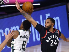 Norman Powell of the Toronto Raptors defends against Eric Bledsoe of the Milwaukee Bucks at The Field House at ESPN Wide World Of Sports Complex on August 10, 2020 in Lake Buena Vista, Florida.