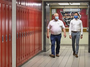 Ontario Premier Doug Ford, left, and Education Minister Stephen Lecce walk the hallway before making an announcement regarding the governments plan for a safe reopening of schools in the fall at Father Leo J Austin Catholic Secondary School in Whitby, Ont., on Thursday, July 30, 2020.
