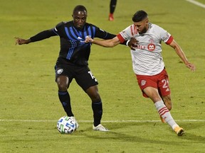 Montreal Impact defender Zachary Brault-Guillard (left) plays the ball and Toronto FC midfielder Jonathan Osorio defends at Stade Saputo in Montreal last night. USA Today