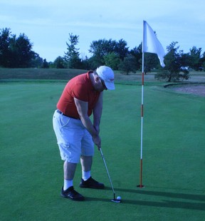 Donald Duench prepares to putt during a lesson for beginner golfers at Mayfield Golf Club in Caledon East.