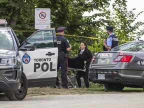 A body is removed from the water at  Bluffer's Park in Toronto, Ont. on Monday August 17, 2020.
