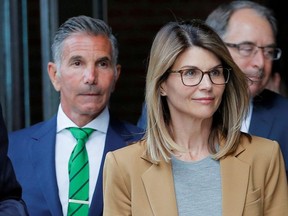 Actor Lori Loughlin, and her husband, fashion designer Mossimo Giannulli, leave the federal courthouse after facing charges in a nationwide college admissions cheating scheme, in Boston, April 3, 2019.