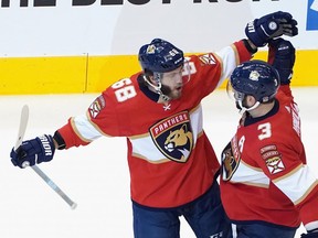 Panthers winger Mike Hoffman, left, celebrates his power-play goal with defenceman Keith Yandle. The Pantehrs beat the Islanders 3-2 on Wednesday to stay alive in their series. GETTY IMAGES