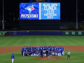 The Toronto Blue Jays pose for a photo on the mound at Sahlen Field after  clinching a post-season berth at Sahlen Field on September 24, 2020 in Buffalo,