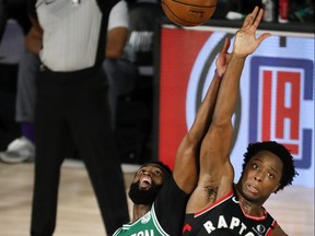 Celtics’ Jaylen Brown (left) and the Raptors’ OG Anunoby fight for possession of the ball during double overtime in Game 6. The winner of tonight’s game will play the Heat.