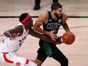 Raptors’ Pascal Siakam, who did not play well in the Raptors’ seven-game ouster at the hands of the Boston Celtics, reaches in to try and stop Jayson Tatum on Friday night.