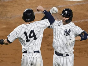 Kyle Higashioka, left, of the New York Yankees celebrates with Tyler Wade after Higashioka hit a two-run home run during the third inning against the Toronto Blue Jays at Yankee Stadium on Sept. 16, 2020 in New York City.