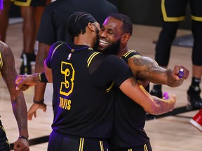 Lakers’ LeBron James (right) celebrates with Anthony Davis after the big centre sank a three-point basket to beat the Nuggets in Game 2 of their series on Sunday.