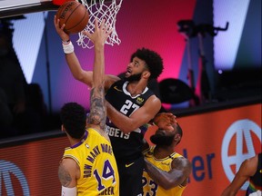 Jamal Murray, centre, of the Nuggets drives to the basket against Lakers defenders Danny Green (14) and LeBron James (23) during the second quarter in Game 4 of the Western Conference Finals during the 2020 NBA Playoffs at AdventHealth Arena at the ESPN Wide World Of Sports Complex in Lake Buena Vista, Fla., Thursday, Sept. 24, 2020.