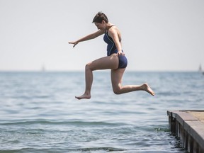 Cassandra Riley is pictured jumping into Lake Ontario at Toronto's eastern beaches on July 18, 2020.