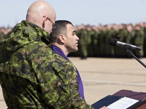 Chaplins Capt. Steven Defer (left) and Capt. Joe Almeida lead a prayer during National Day of Honour ceremonies at CFB Edmonton in Edmonton, Alta., on Friday, May 9, 2014. The cross-Canada event was held in recognition of the Canadian military's contributions to the military mission in Afghanistan. Ian Kucerak/Edmonton Sun/QMI Agency