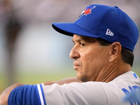 LOS ANGELES, CALIFORNIA - AUGUST 21:  Manager Charlie Montoyo #25 of the Toronto Blue Jays looks on to the field during the first inning against the Toronto Blue Jays at Dodger Stadium on August 21, 2019 in Los Angeles, California. (Photo by Harry How/Getty Images)
