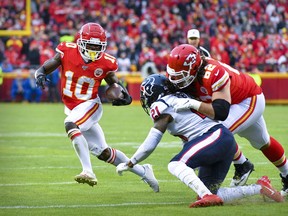 Kansas City Chiefs wide receiver Tyreek Hill runs with the ball against the Houston Texans during the third quarter of a 2019 AFC playoff game at Arrowhead Stadium.