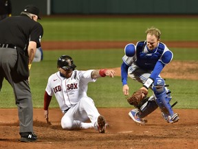 Red Sox base-runner Christian Vazquez scores the winning run ahead of the tag by Blue Jays catcher Caleb Joseph in the ninth inning at Fenway Park.