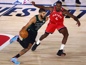 Celtics forward Jayson Tatum dribbles the ball against Raptors forward Rondae Hollis-Jefferson (4) during Game 5 on Monday.