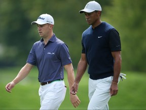 Sep 17, 2020; Mamaroneck, New York, USA; Justin Thomas (L) and Tiger Woods (R) walk down the 12th fairway during the first round of the U.S. Open golf tournament at Winged Foot Golf Club - West.