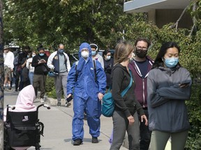 People line up on Bathurst St. for a Covid-19 test at the Covid-19 Assessment Centre at Bathurst and Dundas St.  beside Toronto Western hospital.  on Tuesday September 15, 2020. Craig Robertson/Toronto Sun/Postmedia Network