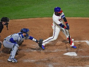 Phillies centre fielder Andrew McCutchen (right) hits an RBI single during the fifth inning against the Blue Jays at Citizens Bank Park in Philadelphia, Saturday, Sept. 19, 2020.