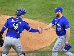 Toronto Blue Jays catcher Danny Jansen (left) and relief pitcher Anthony Bass celebrate a win over the Philadelphia Phillies at Citizens Bank Park on Sunday.