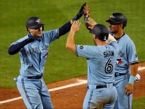 Toronto Blue Jays catcher Danny Jansen (9) celebrates his grand slam home run with second baseman Travis Shaw during Monday's game against the New York Yankees at Sahlen Field.