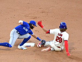 Toronto Blue Jays shortstop Bo Bichette (11) tags out Philadelphia Phillies third baseman Alec Bohm during the seventh inning at Citizens Bank Park on Sunday.
