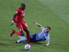Toronto FC’s Chris Mavinga (left) battles for possession with New York City FC’s Valentin Castellanos during Wednesday’s match in Harrison, N.J. It was Mavinga’s 100th appearance with the Reds.
