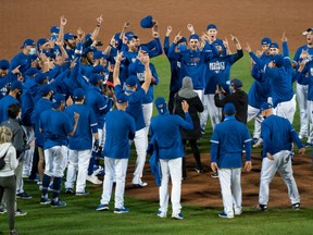 The Toronto Blue Jays celebrate at the pitchers mound after clinching a playoff spot following a victory over the New York Yankees at Sahlen Field Sept. 24, 2020.