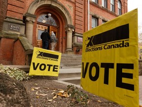 Voters are seen outside of a polling station during the Federal Election in Edmonton, Oct. 21, 2019.