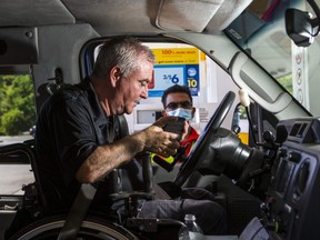 Barry Munro, Chief Development Officer for the Canadian Spinal Research Organization), demonstrates the use of a new app, Fuel Service, at the Shell gas station at the corner of Yonge St. and York Mills Rd. in Toronto, Ont.  on Thursday September 3, 2020.