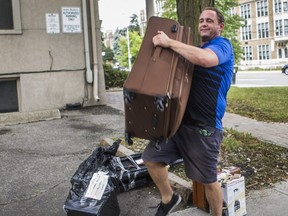 Grady Rowand, a resident of the Roehampton shelter who has just been kicked out, loads his belongings into a friend's car in Toronto, Wednesday Sept. 2, 2020.