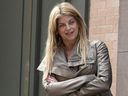 Kirstie Alley waits to enter an apartment next door to the townhouse where former IMF head Dominique Strauss-Kahn is being held under house arrest in New York on May 28, 2011.