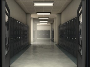 A dimly lit hallway of school lockers.