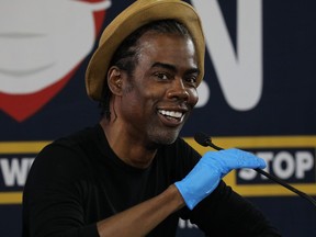 Chris Rock  joins New York Governor Andrew Cuomo and Rosie Perez at a press conference where the two performers helped to promote coronavirus testing, social distancing and the use of a face mask on May 28, 2020 in New York City.