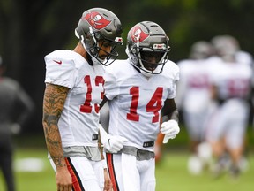 Wide receivers Chris Godwin (right) and Mike Evans of the Tampa Bay Buccaneers talk things over during training camp at  the AdventHealth Training Center last month.