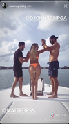 Dustin Johnson, left, and a pal lift Paulina Gretzky out of a boat in a screengrab from a video shared on Instagram story.