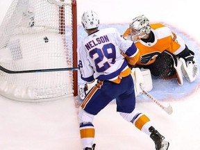 New York Islanders’ Brock Nelson scores a goal on Philadelphia goalie Carter Hart during Game 7 of their series last night. The Isles face the Tampa Bay Lightning in the Eastern Conference final to be played in Edmonton. Getty Images