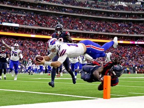 Buffalo Bills quarterback Josh Allen (17) scores a touchdown against Houston Texans strong safety Jahleel Addae (37) during the first quarter in the AFC wild-card game at NRG Stadium last season.